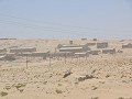 zicht op de spookstad Kolmanskop bij winderig weer