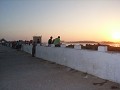 Tourists watching the sunset on the wall. Had to b