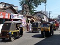 Tuk tuks in front of a small temple